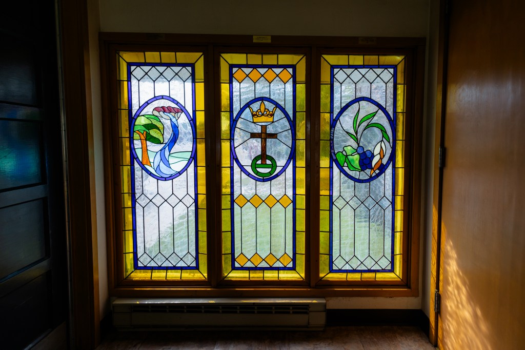 Stained glass with United Church of Christ logo in the center